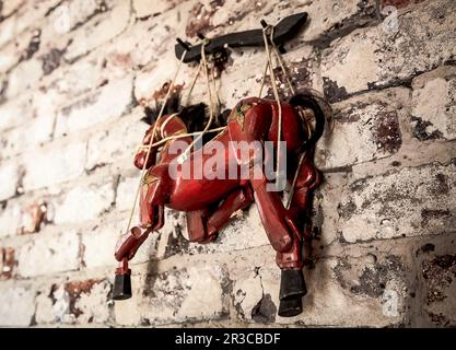 Wooden String Puppet Horse hanging on a wall Stock Photo