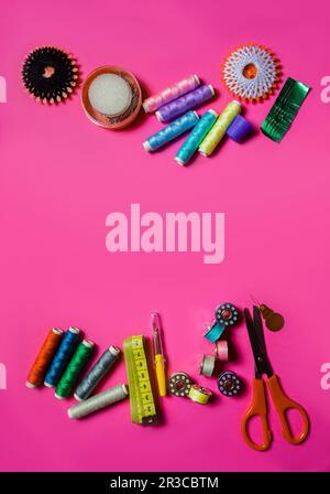 Non-professional set of sewing instruments on pink surface Stock Photo