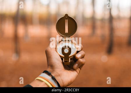 Traveler holding compass in hand, Blurred background Stock Photo