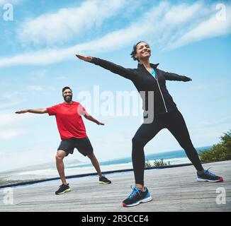 Fitness, health and couple doing outdoor pilates stretching together for body balance exercise. Happy, smile and young man and woman doing a yoga warm Stock Photo
