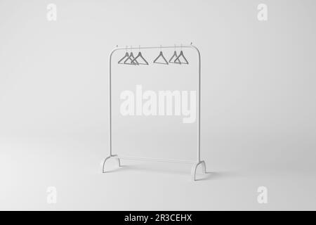 White clothes rail with hangers casting shadow on white background in greyscale monochrome. Concept of minimalism, boutiques and fashion Stock Photo