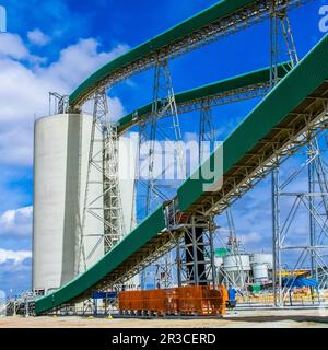 Platinum Mining and Processing of ore, Conveyor belt transporting ore rich tock to storage silos Stock Photo
