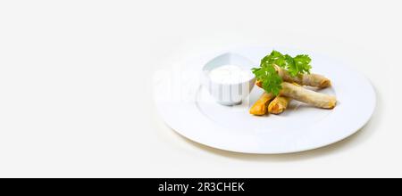 Spring Rolls and dip on a white plate on a white background isolated Stock Photo