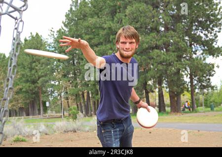 A person playing Disc Golf at the Pine Nursery course in Bend, Oregon. Stock Photo