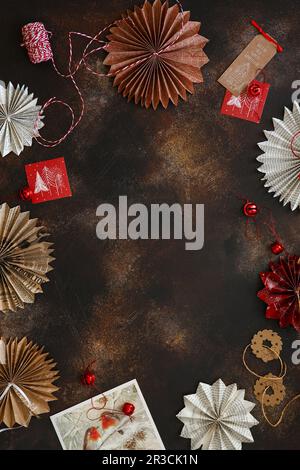 Holiday background with copy space. Handmade paper Christmas tree toys made from wrapping paper and Stock Photo