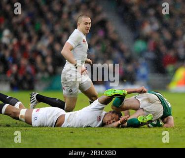 Courtney Lawes of England lies injured after tackling Rob Kearney of Ireland during the RBS 6 Nations match between Ireland and England at the Aviva S Stock Photo