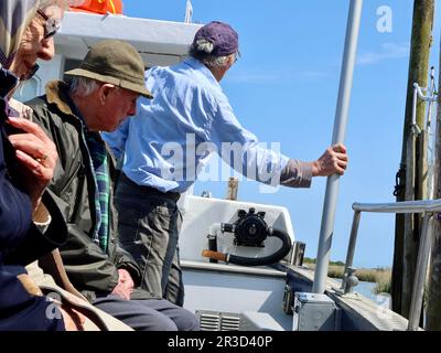 Snape Maltings, Suffolk, UK - 23 May 2023 : Setting off for a boat trip  on Tilly Too on the River Alde. Seniors enjoying the trip. Stock Photo