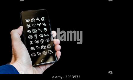 Hand Holding a Smartphone with Health and Medical Icon Apps on the Screen Stock Photo