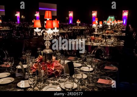 Decor with candles, flowers and lamps for a large corporate party event or Gala Dinner Stock Photo