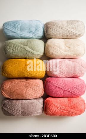 colorful wool threads for knitting in basket, wooden background Stock ...