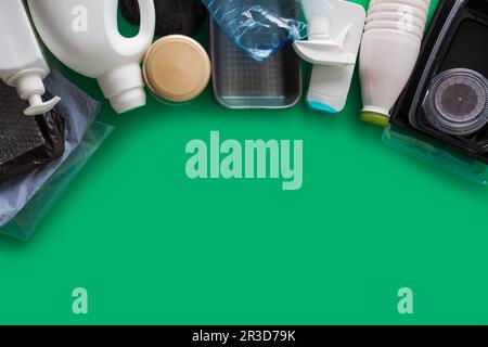 Processing plastic concept. Plastic containers on the green Stock Photo