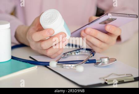 Over shoulder view of young asia woman talk to doctor on cellphone videocall conference medical app in telehealth telemedicine online service hospital Stock Photo