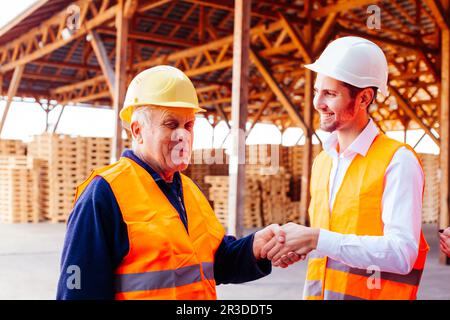 Young company manager thanks to senior foreman Stock Photo