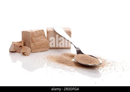 Fresh pressed and dry instant yeast on white background. Stock Photo