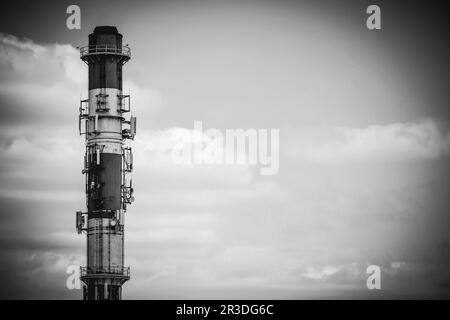 High heating plant chimney with antennas Stock Photo