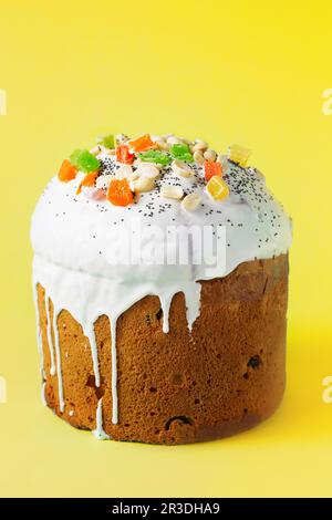 Easter Cake - Russian and Ukrainian Traditional Kulich on a bright yellow background. Paska Easter Bread. Happy easter. Kulich c Stock Photo