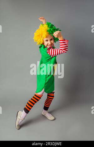 The little girl in a clown uniform has fun Stock Photo