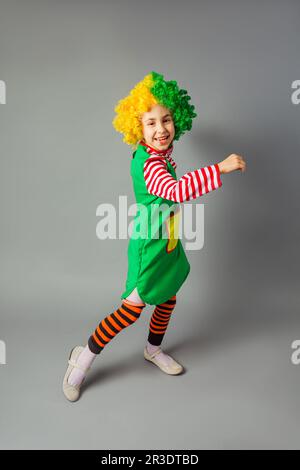 The little girl in a clown uniform has fun Stock Photo