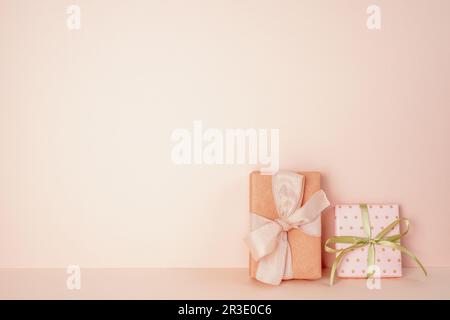 Pink gift boxes on pink table. pink wall background. copy space Stock Photo