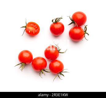 Ripe fresh organic cherry tomatoes with green stems on a white background close-up top view. Small beautifully shaped tomatoes isolated. Stock Photo