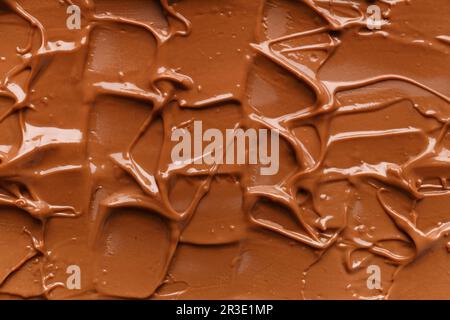 Chocolate background. Melted chocolate. Liquid milk chocolate. Handmade chocolate. Stock Photo