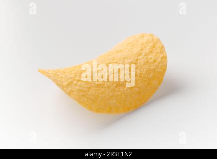One potato chip isolated on white background, beer snacks, crispy chips. Stock Photo