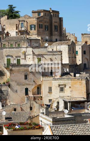 View above the rooftops of old town Matera, Basilicata region of Italy. Rooftop gardener old man, with vast view of old town in the bacgkround Stock Photo