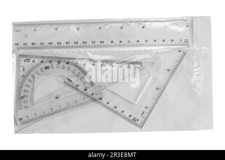 set of packaging Plastic ruler, protractor, triangle, isolated on white background Stock Photo