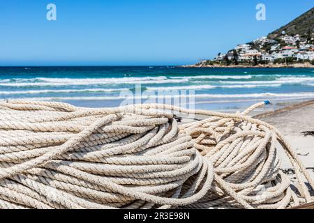 Traditional fishing net on small rowing boat on beach Stock Photo