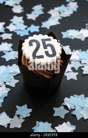 Number 25 on Delicious chocolate cupcake with cream on dark background. Muffin. Birthday cake party. 25 years old anniversary Stock Photo