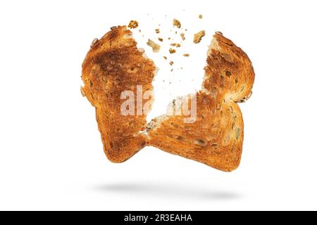 White bread slice isolate broken into 2 pieces with flying crumbs. Toaster fried bread isolated on white background. The concept of a small, dietary Stock Photo