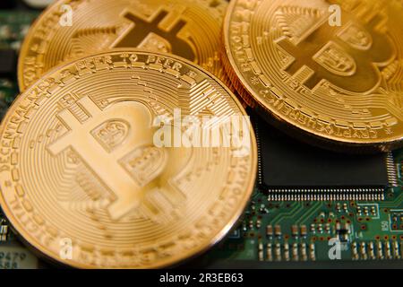 Conceptual cryptocurrency bitcoins on a computer motherboard Stock Photo