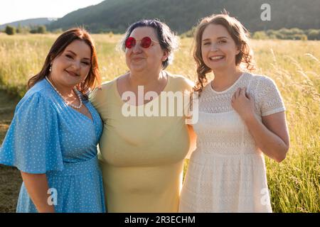 The happy girlfriends are hugging in nature Stock Photo