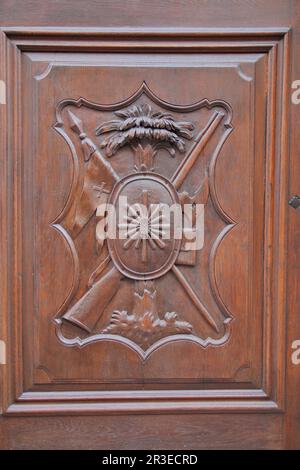 Photo taken in Bratislava. In the photo, a masterfully executed relief carving on a wooden door. Stock Photo