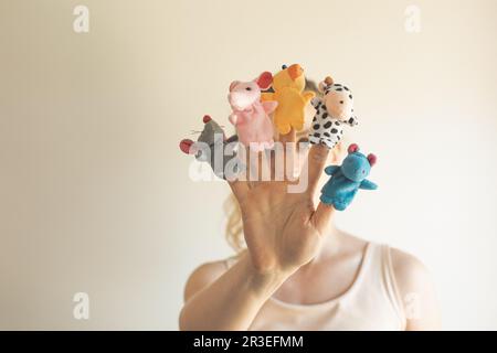 Woman hand wearing five finger puppets close up Stock Photo