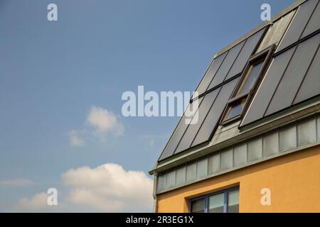 Modern house with blue solar panels on the roof  - sustainable energy Stock Photo