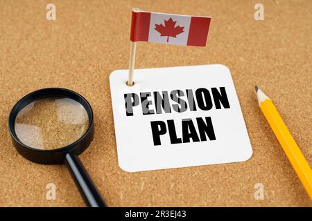 On the table is the flag of Canada, a pencil, a magnifying glass and a sheet of paper with the inscription - pension plan Stock Photo