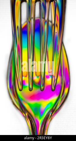 Polarized light through clear plastic utensil abstract Stock Photo