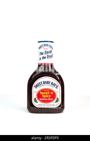 A bottle of Sweet Baby Ray's brand Sweet 'n Spicy Barbecue Sauce on white background. USA. Stock Photo
