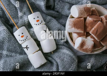 Two happy funny marshmallow snowmen. Marshmallow friends. Diy. Sweet treat for kids funny marshmallow snowman. Christmas winter Stock Photo