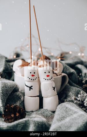 Two happy funny marshmallow snowmen. Marshmallow friends. Diy. Sweet treat for kids funny marshmallow snowman. Christmas winter Stock Photo