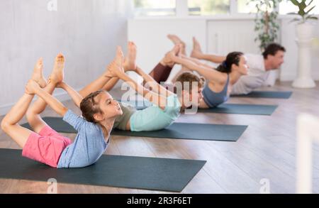 Group Of Yoga Lovers Meditating Together In Child's Pose In Studio  Stock Photo by Prostock-studio
