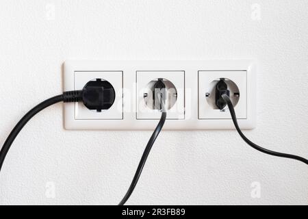 Three cable at a triple socket Stock Photo