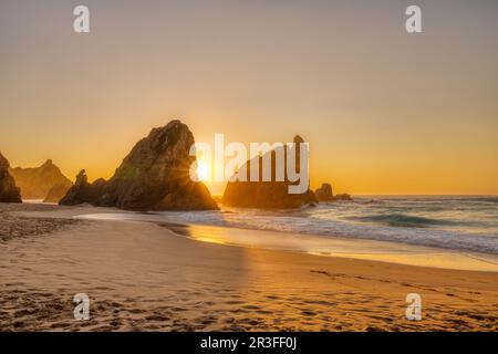 Beautiful sunset on a beach with sea stacks at the portuguese atlantic coast Stock Photo