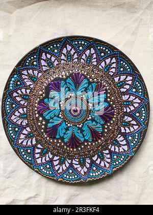 Decorative ceramic plate with  different colors. painted plate on white background, closeup, top view. Decorative porcelain plat Stock Photo