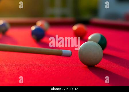 Pool Balls Are Lit On Fire While Sitting On A Pool Table In An Outdoor Environment Stock Photo