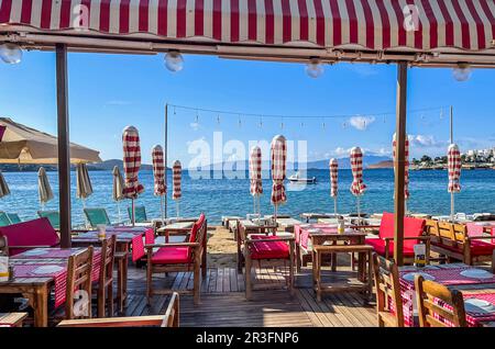 Beach umbrellas, sun loungers and restaurant on the beach. Summer vacation concept Stock Photo
