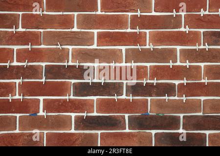 Decorative bricks with tile leveling system on wall Stock Photo