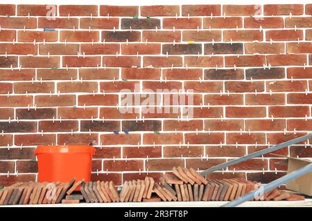 Decorative bricks with tile leveling system on wall Stock Photo
