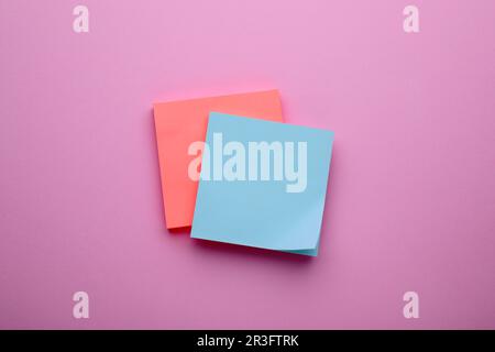 Paper notes on pale pink background, top view Stock Photo